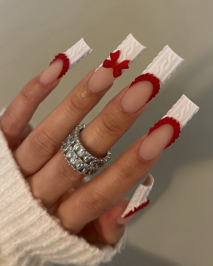 very long christmas nails with white tips and red accents